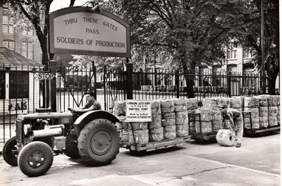 Man driving truck with war supplies made by the workers